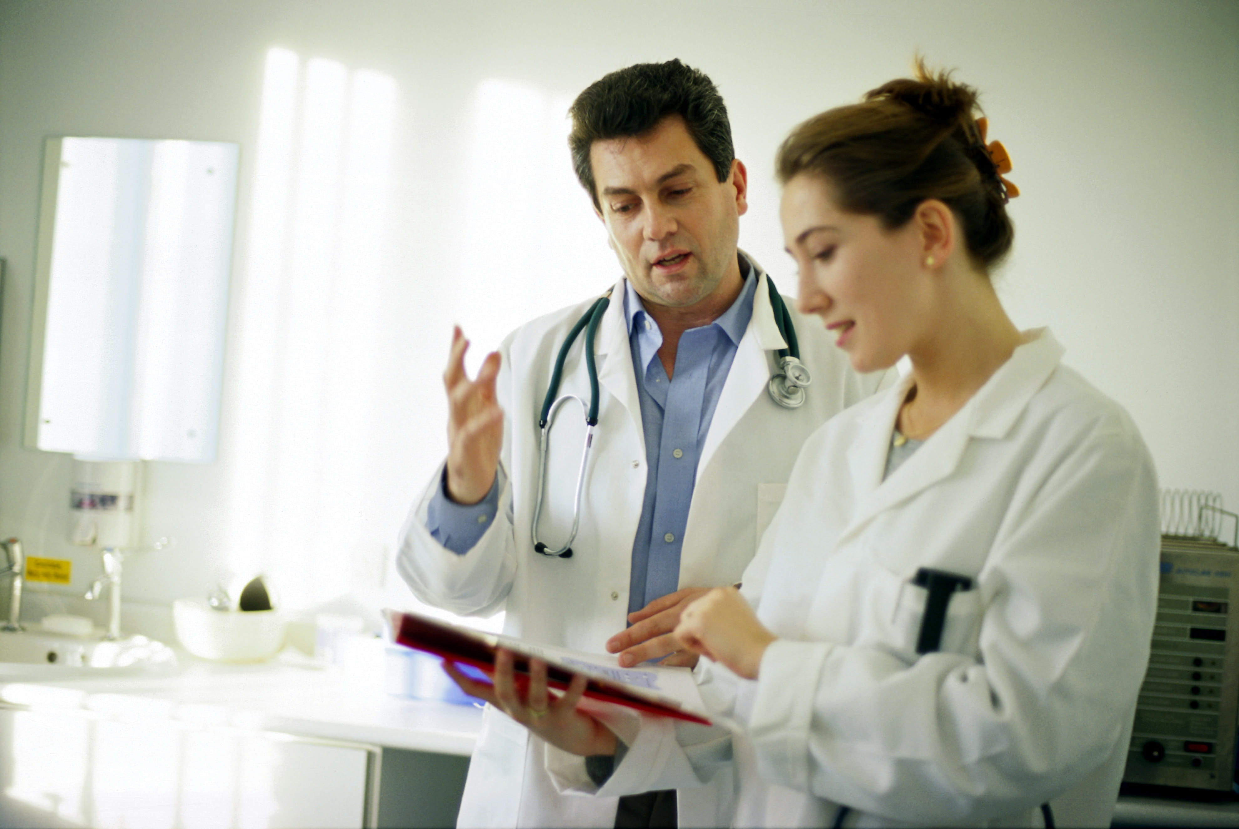 Female and male doctor mid discussion