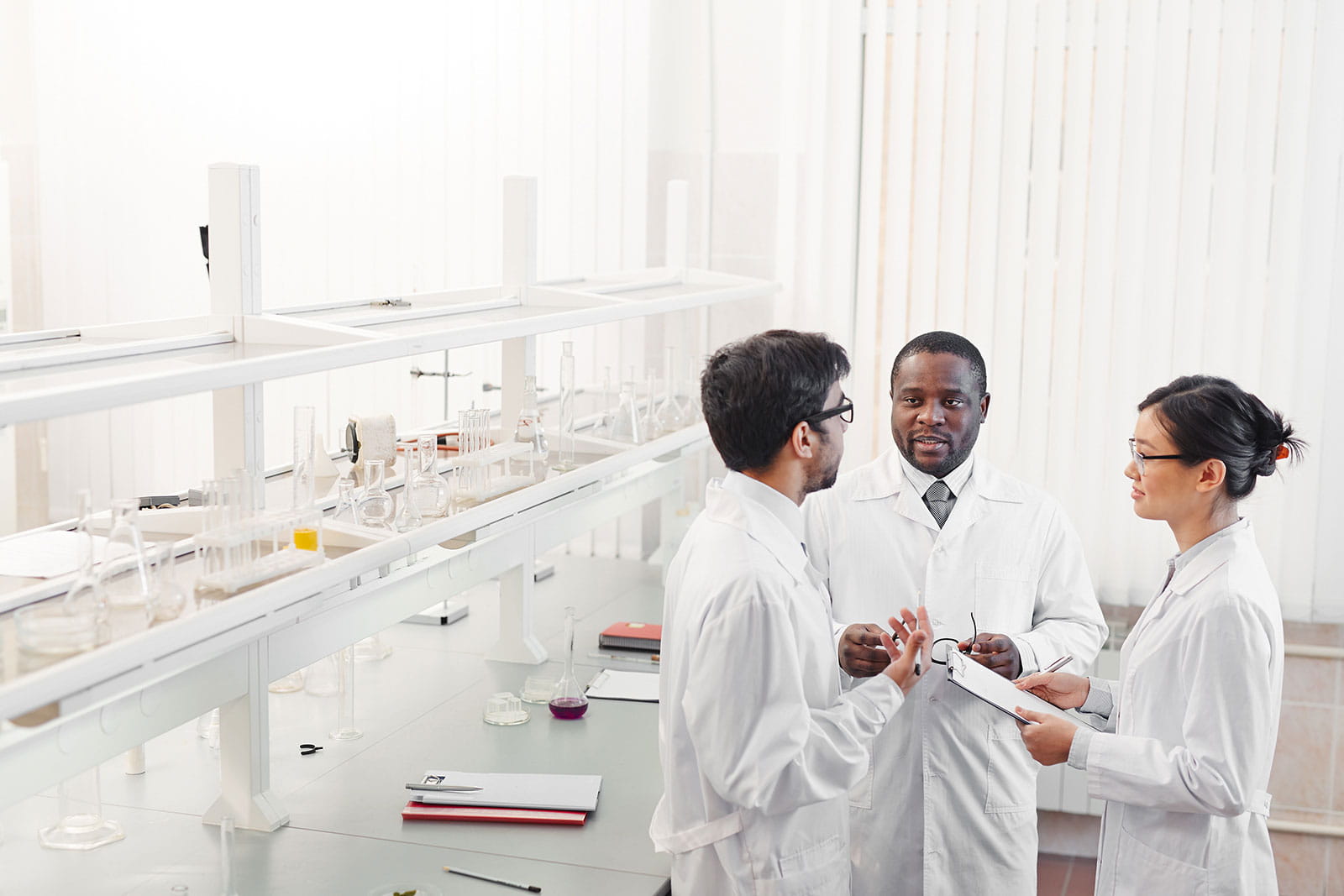 Group of researchers talking in a lab